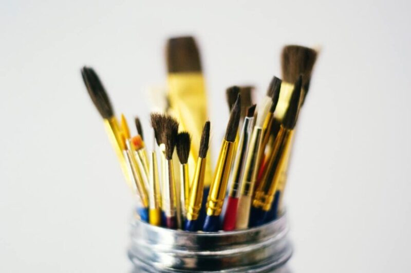 a glass filled with brushes